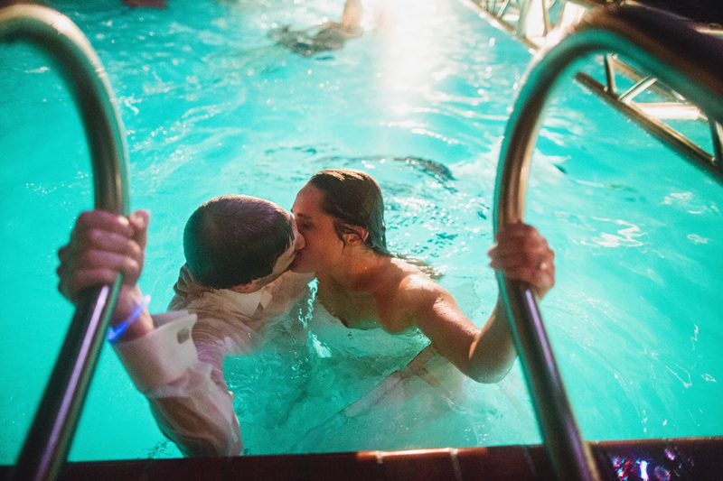 bride and groom in the pool